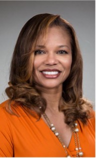 a woman in an orange shirt is smiling for the camera