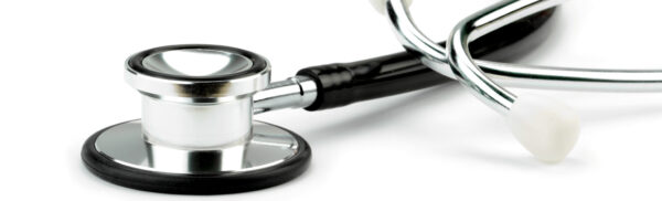 Stethoscope rested on a white surface.